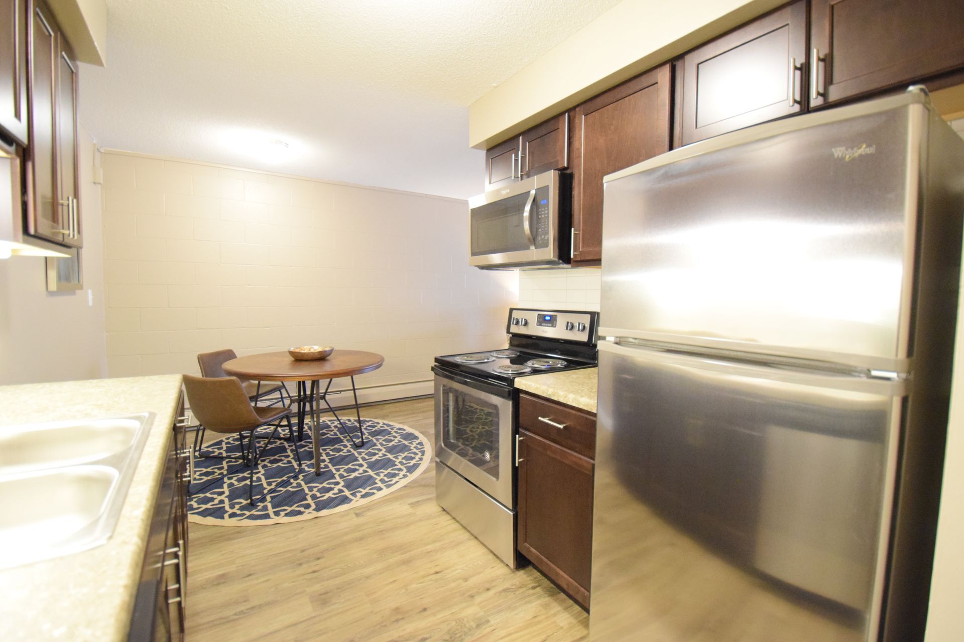 A kitchen with stainless steel appliances and wooden cabinets