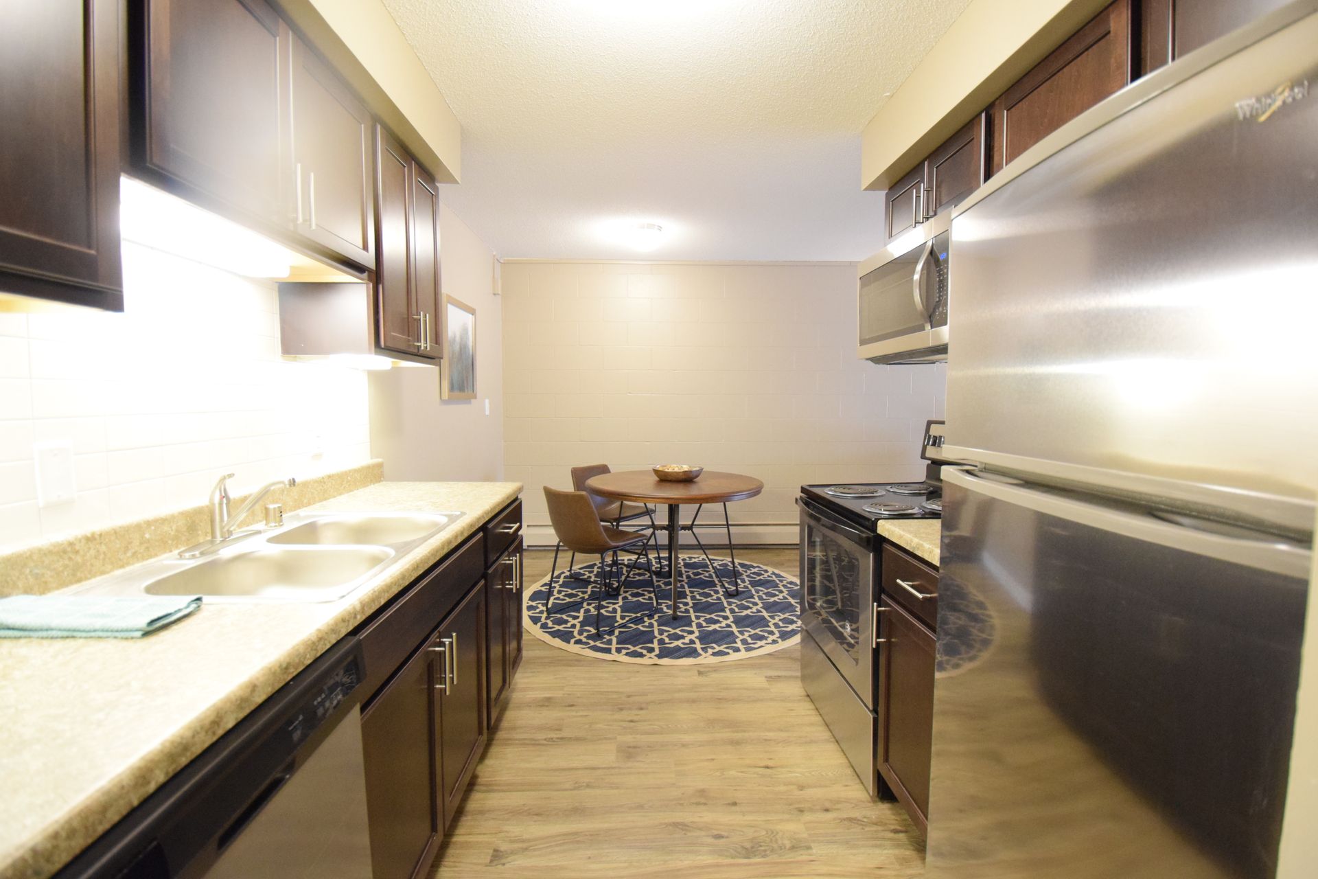 A kitchen with stainless steel appliances and a table