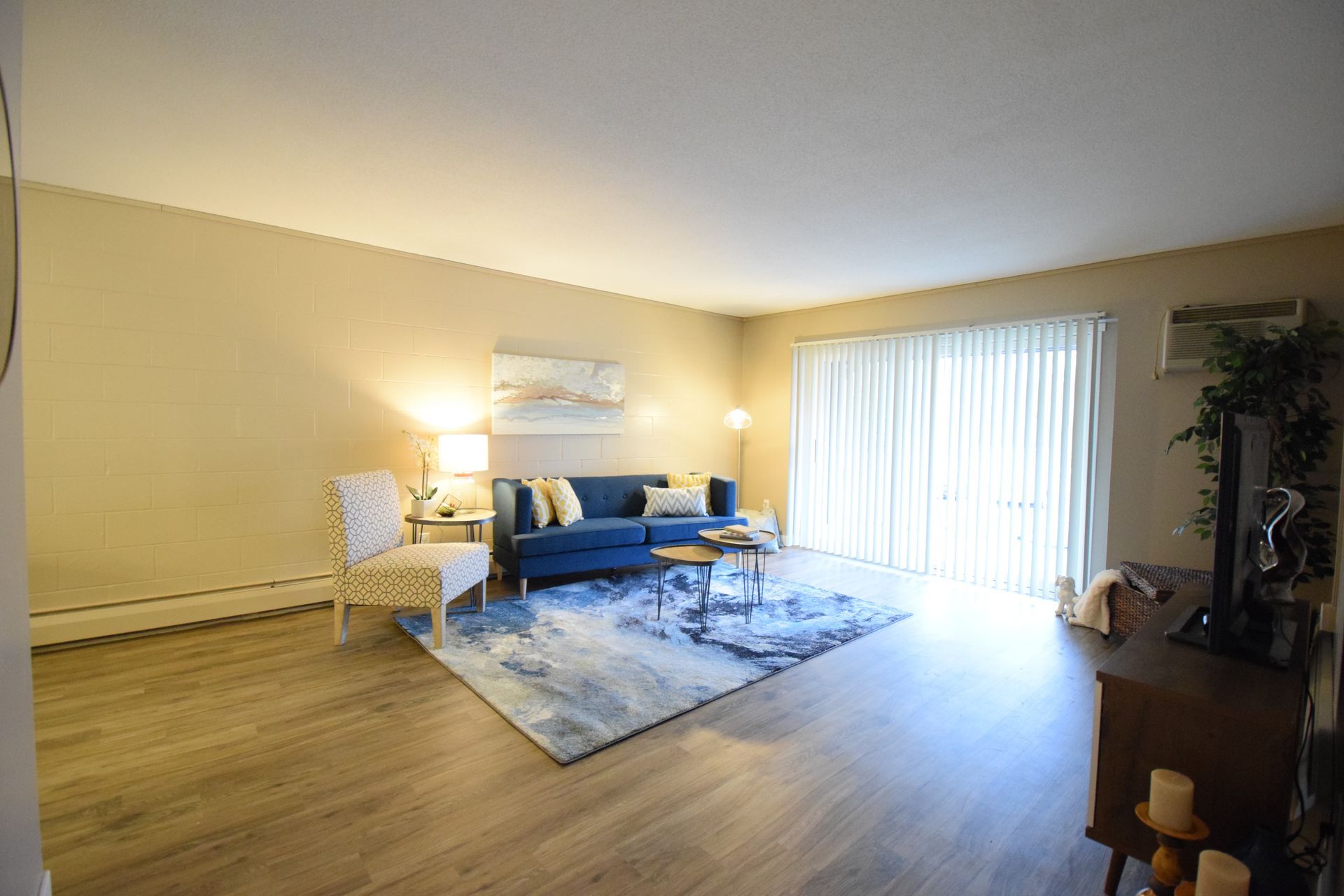 A living room with a couch , chairs , and a television.