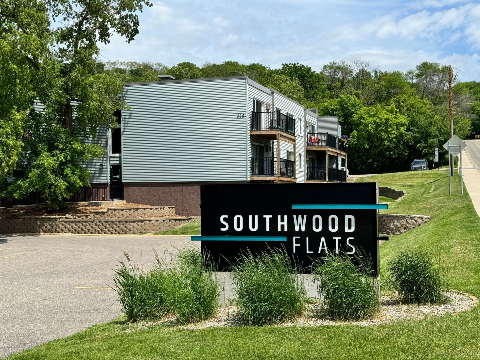 A sign for southwood flats is in front of a building
