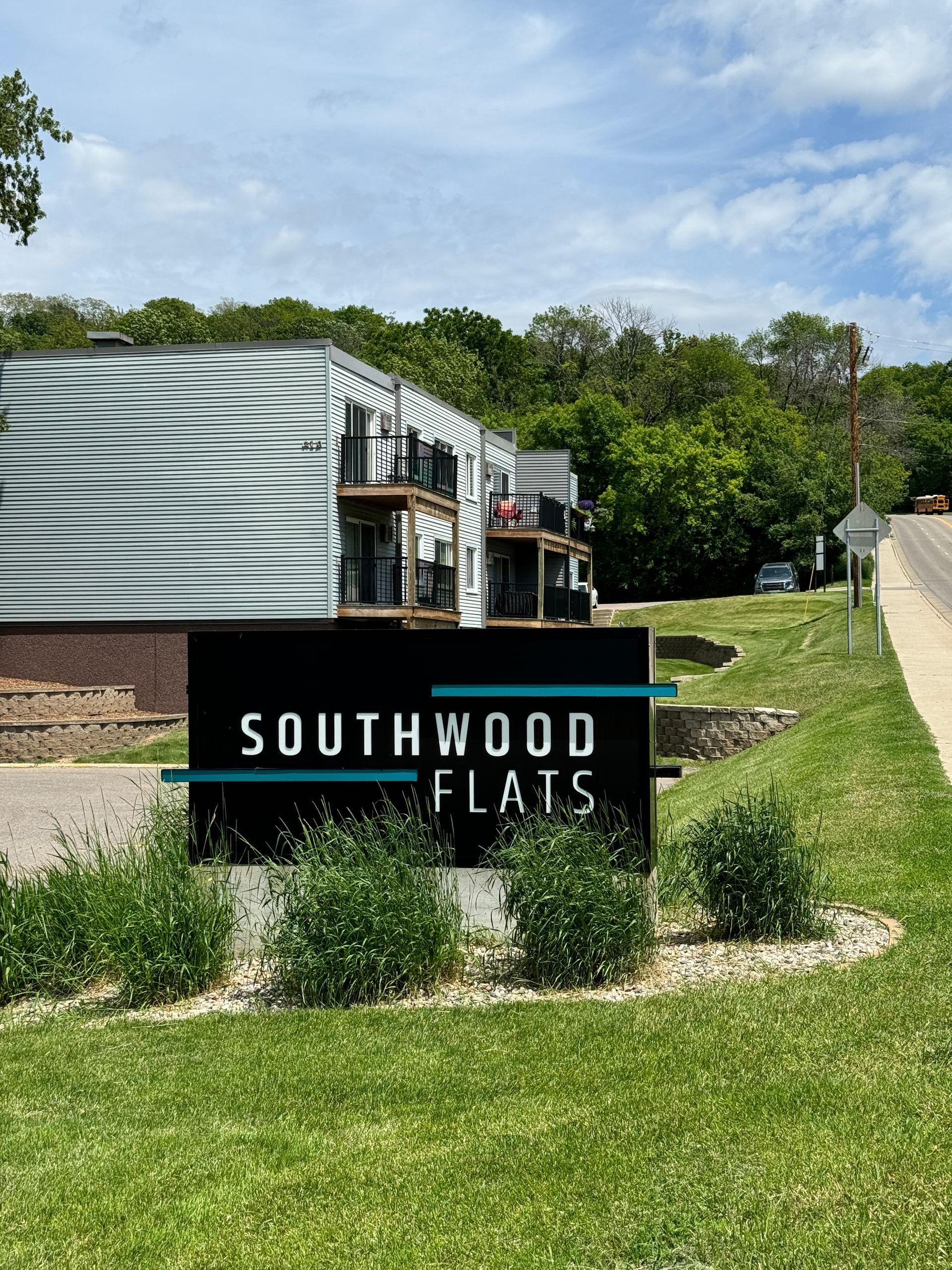 A sign for southwood flats is in front of a building