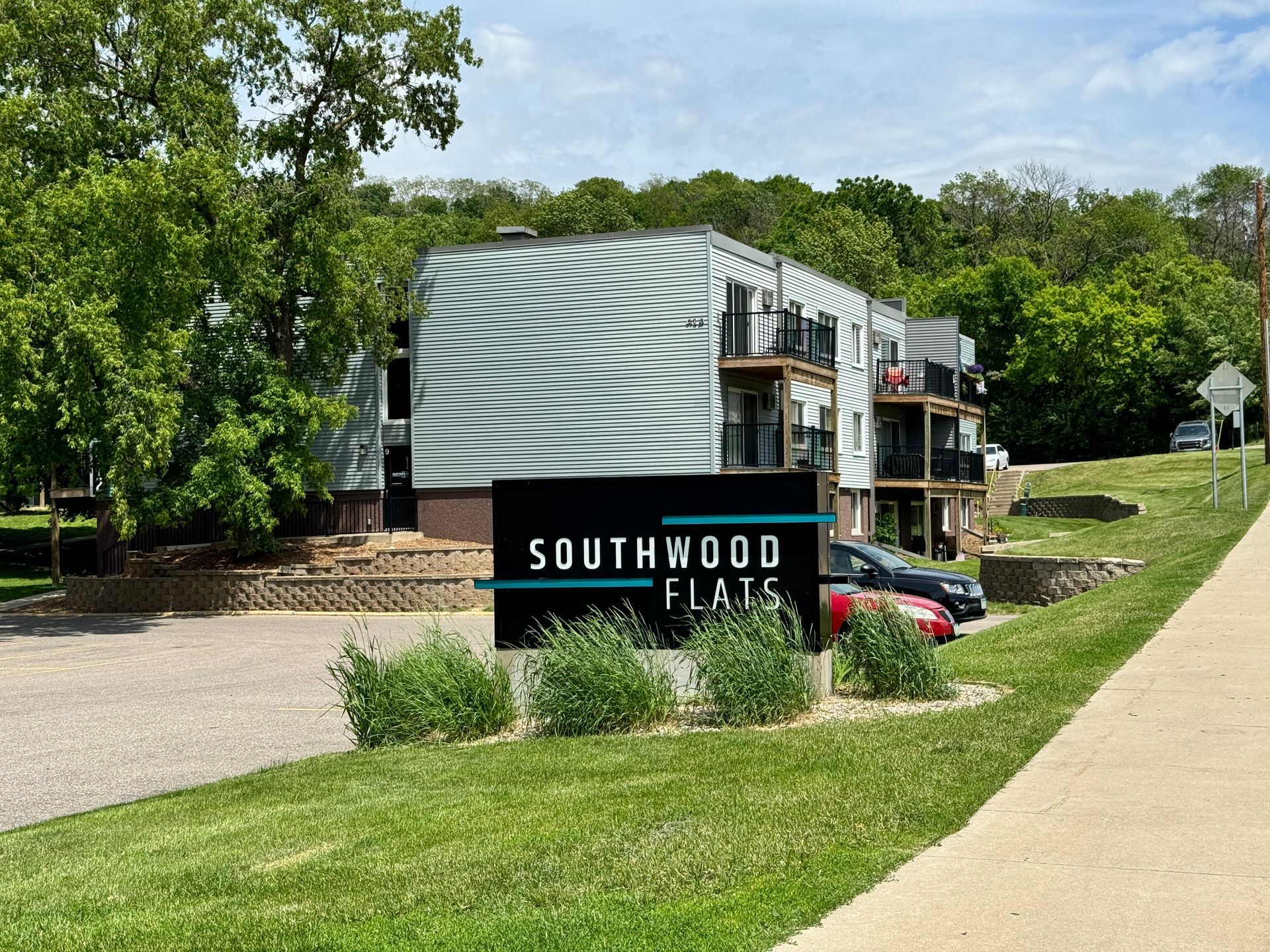 A sign for southwood flats is in front of a building.