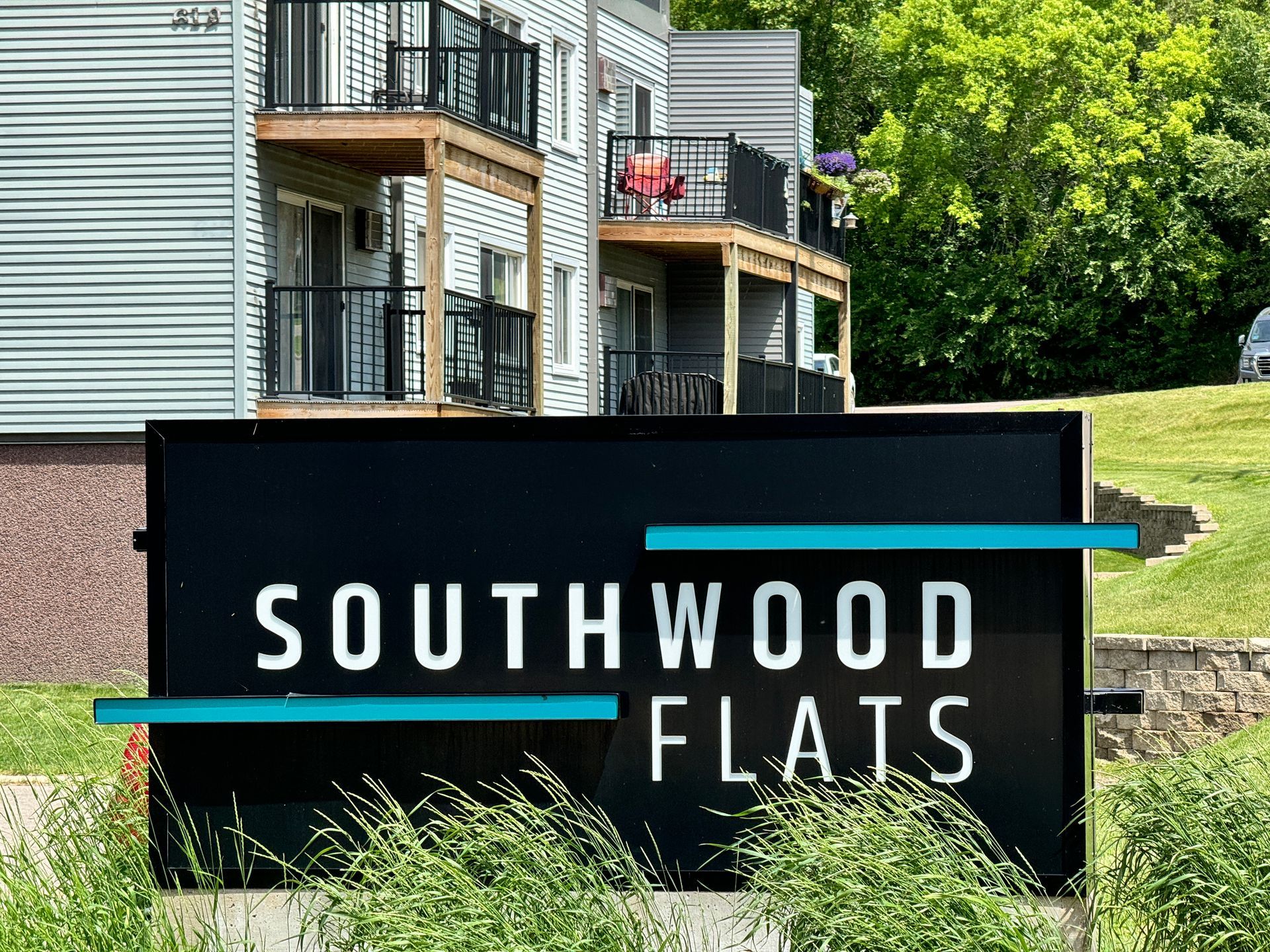A sign for southwood flats is in front of a building.