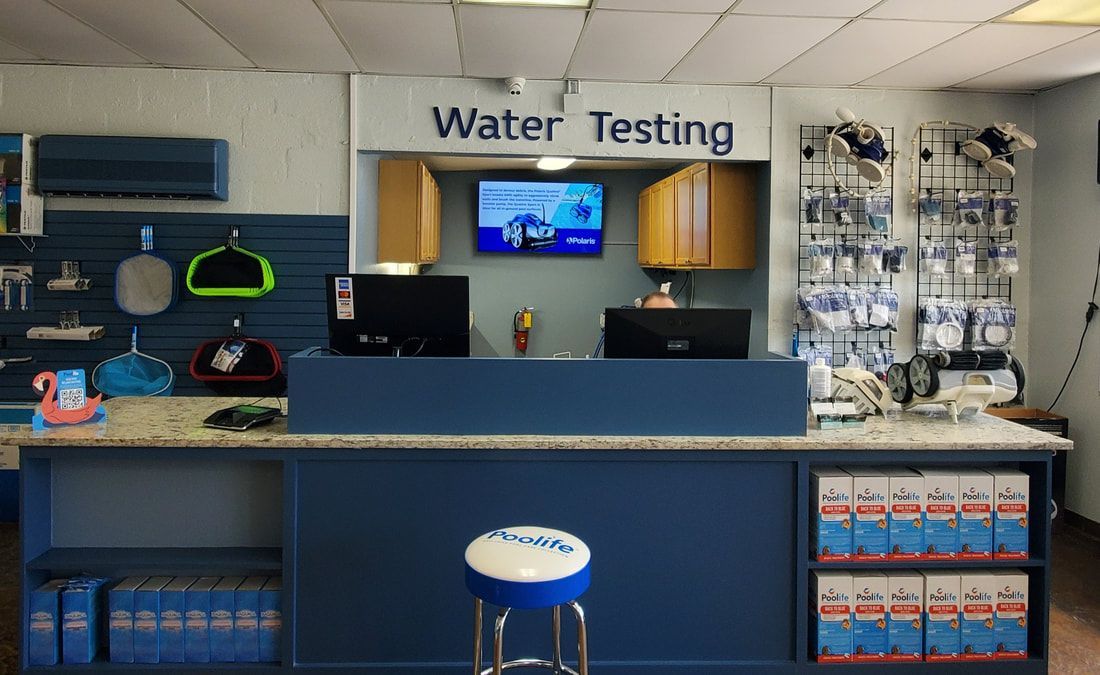 A counter in a store with a sign that says water testing