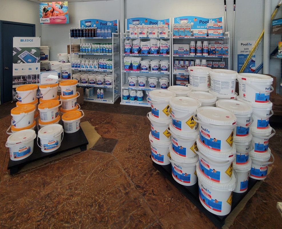 Buckets of chemicals are stacked on top of each other in a store