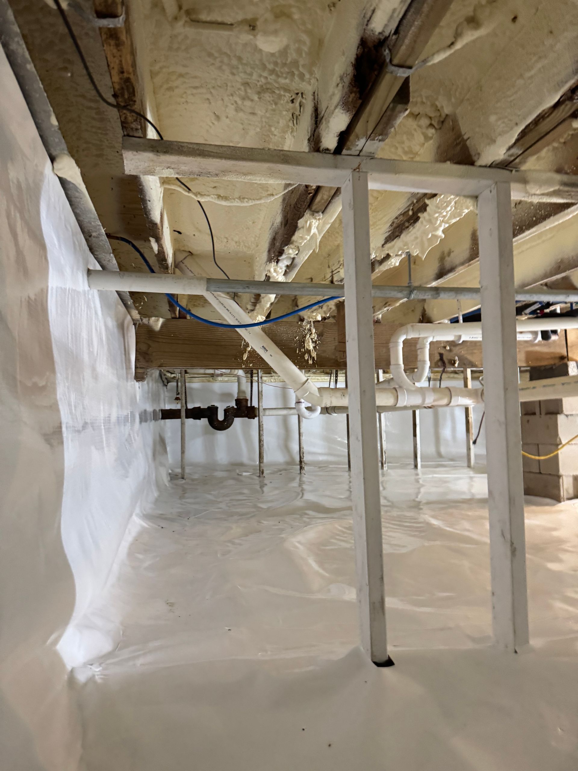 A basement with a lot of pipes coming out of it