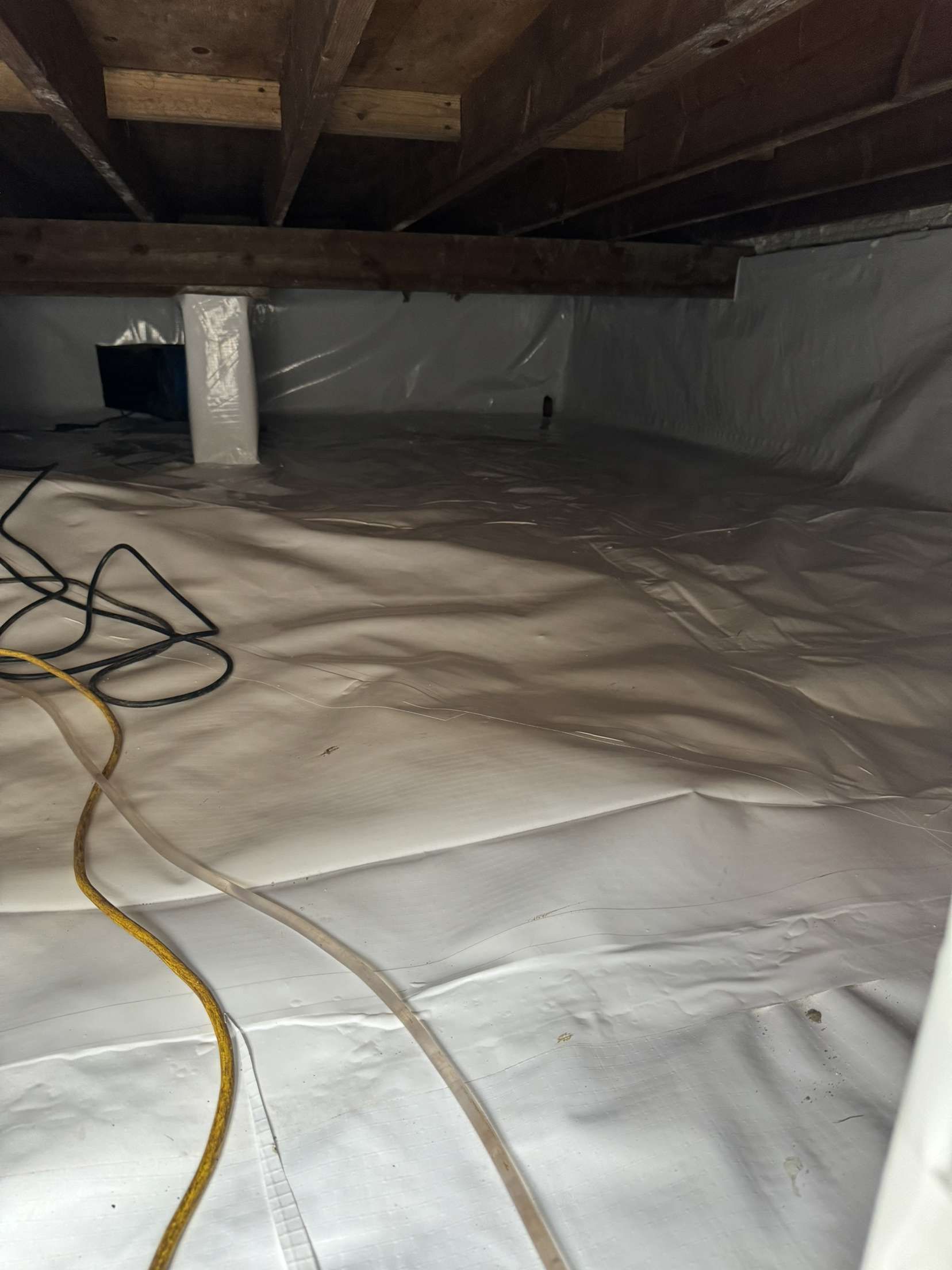 A basement with a lot of plastic on the floor