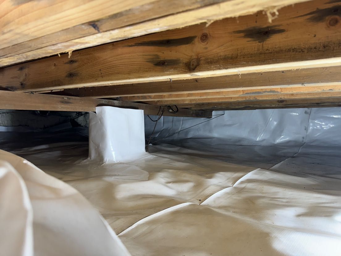 A close up of a crawl space under a house.