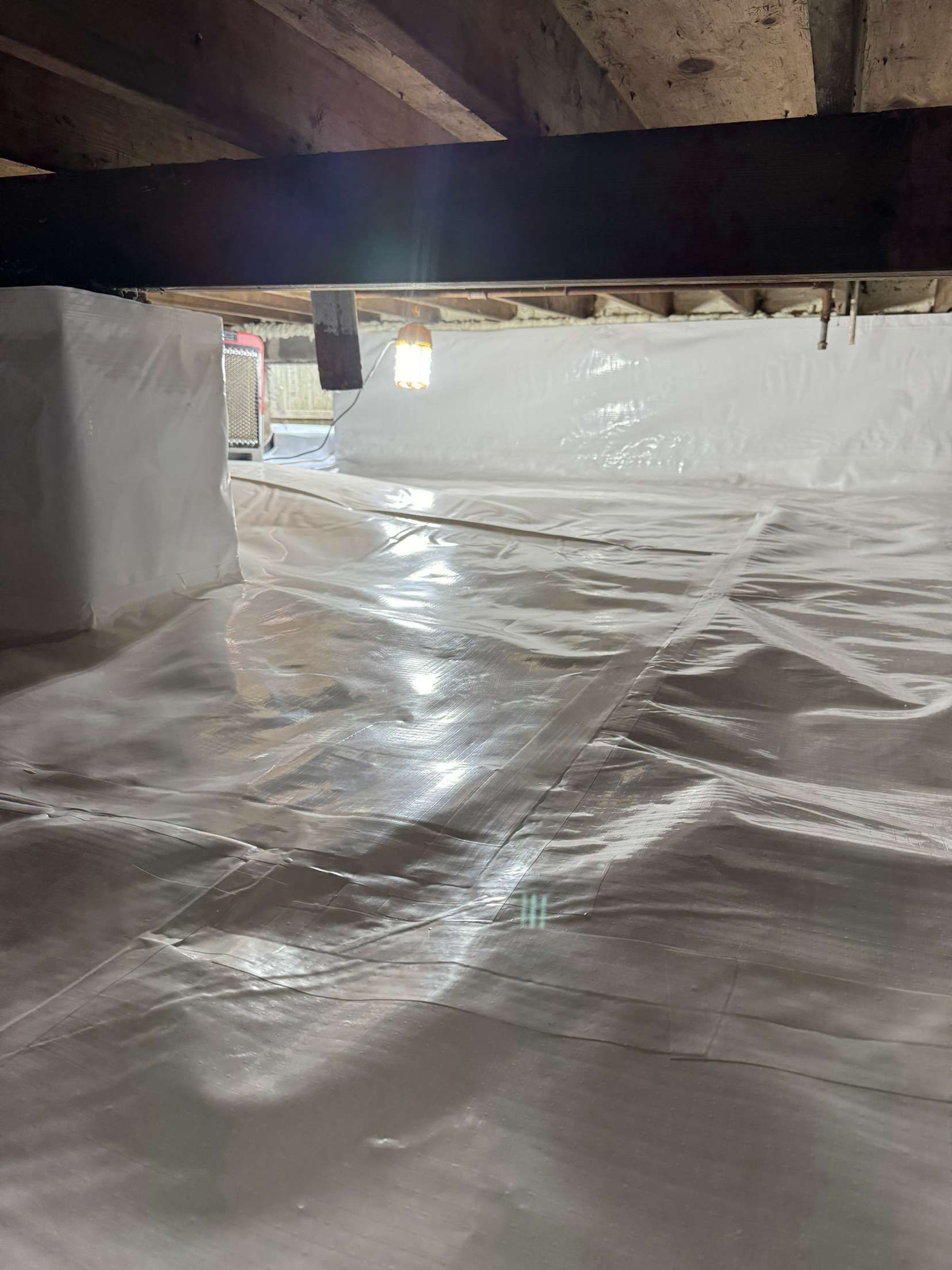 A basement with a lot of insulation on the floor and ceiling.