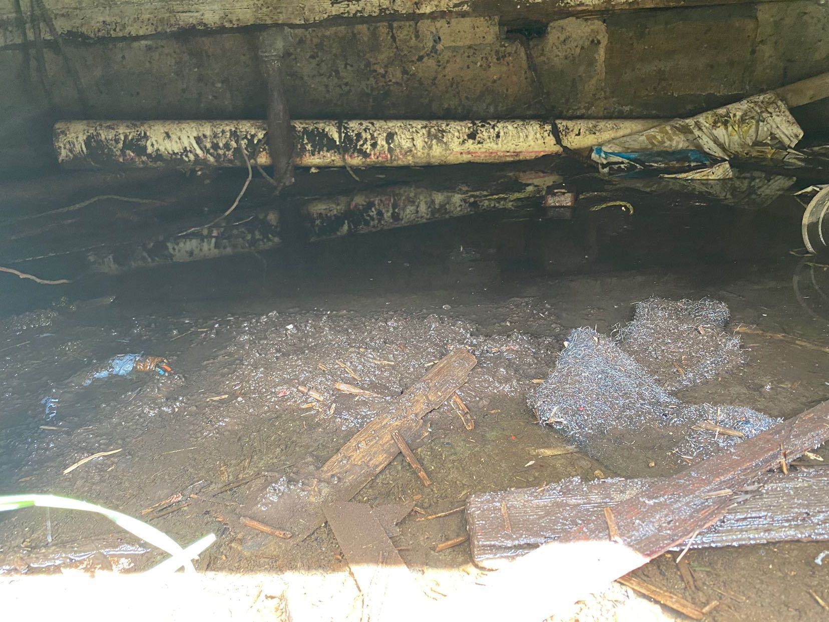 A flooded basement with a lot of water coming out of it.