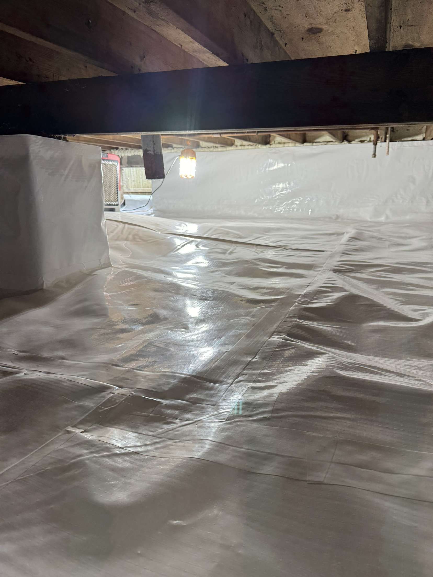 A basement with a lot of insulation on the floor.