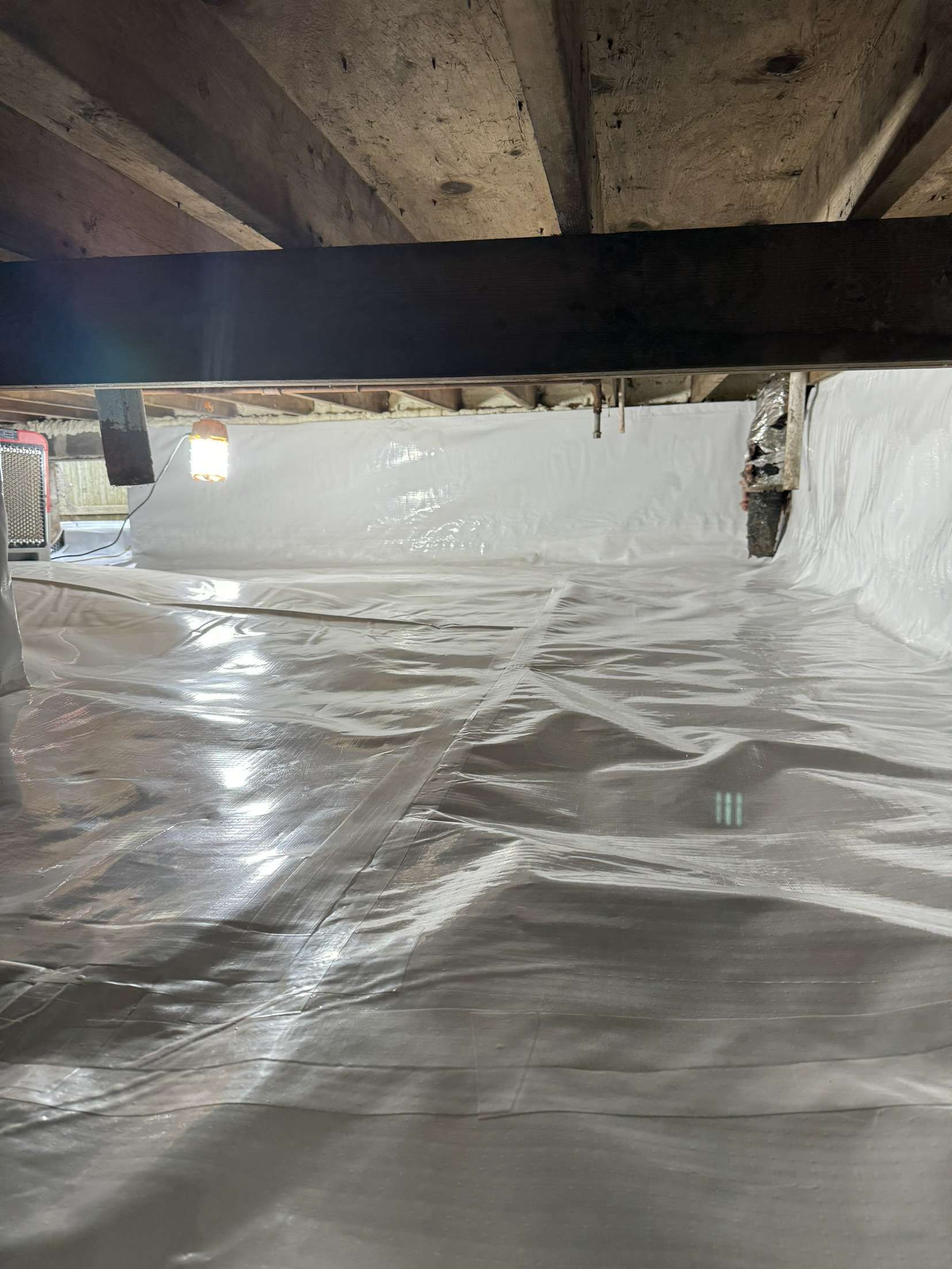 A basement with a lot of plastic covering it.