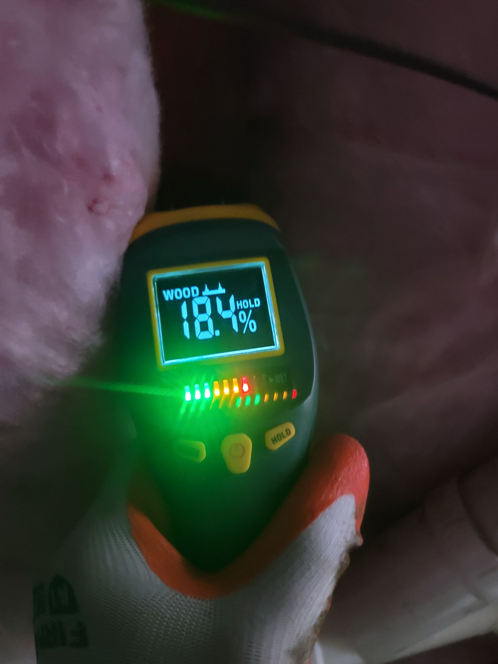 A person is holding a device that says 18.4% on the screen