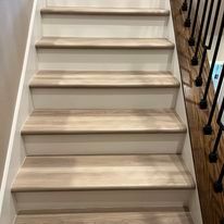 A set of stairs with wooden steps and a metal railing.
