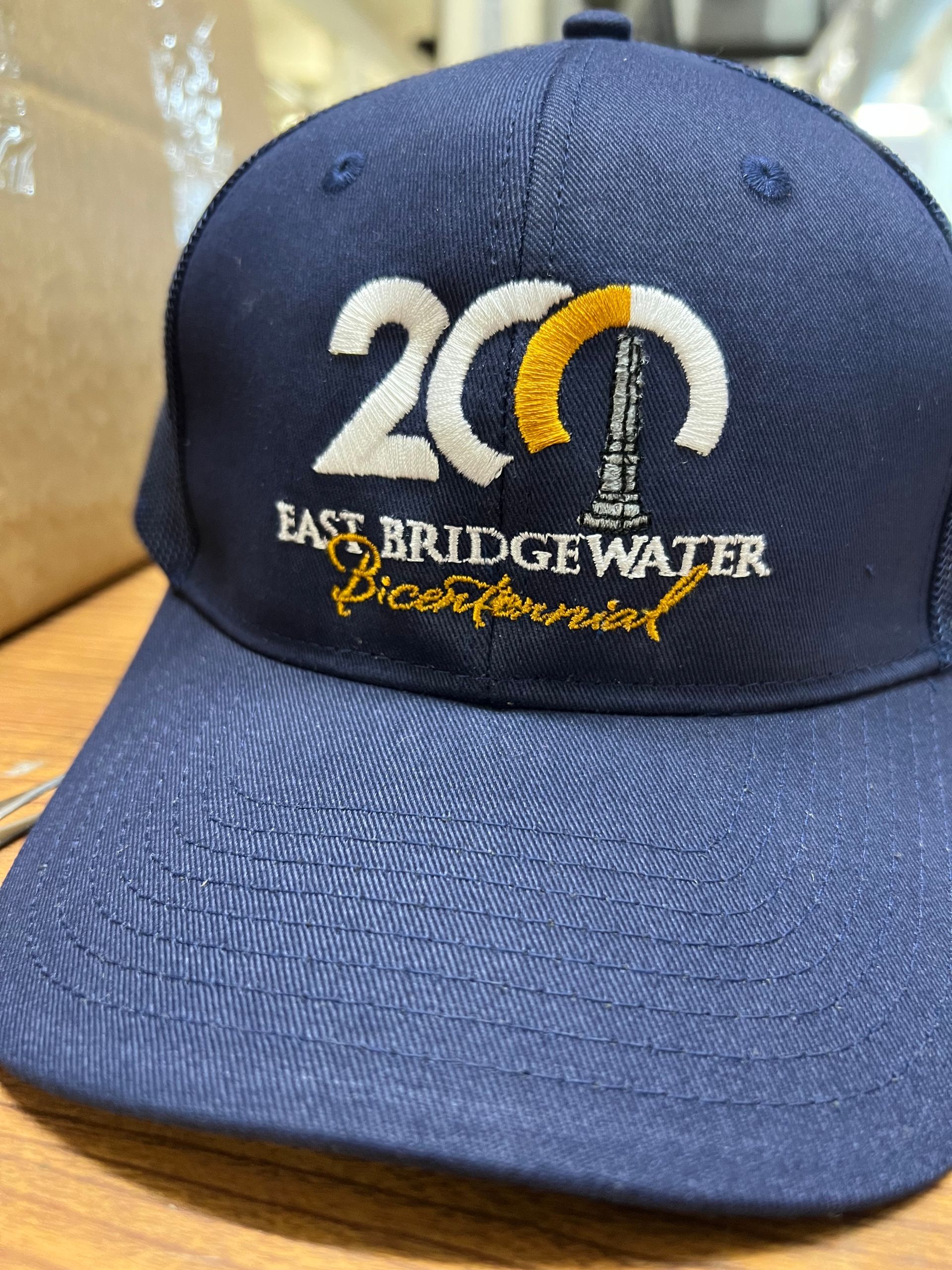 Navy blue baseball cap with custom embroidery featuring 