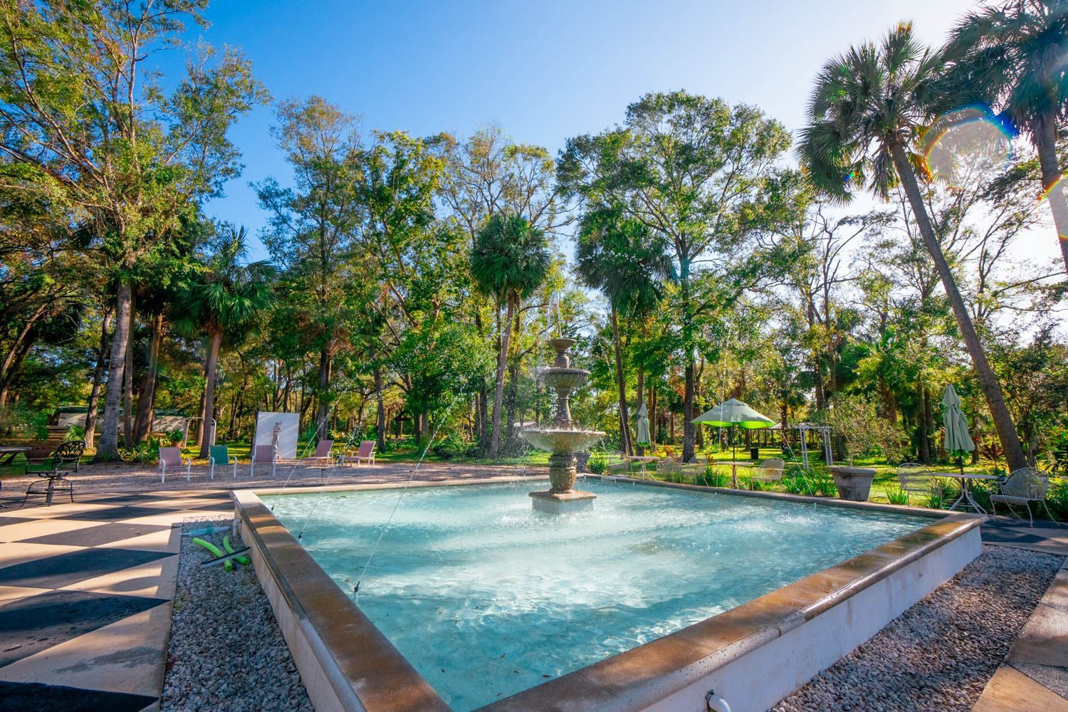 A white rocking chair is sitting in front of a building