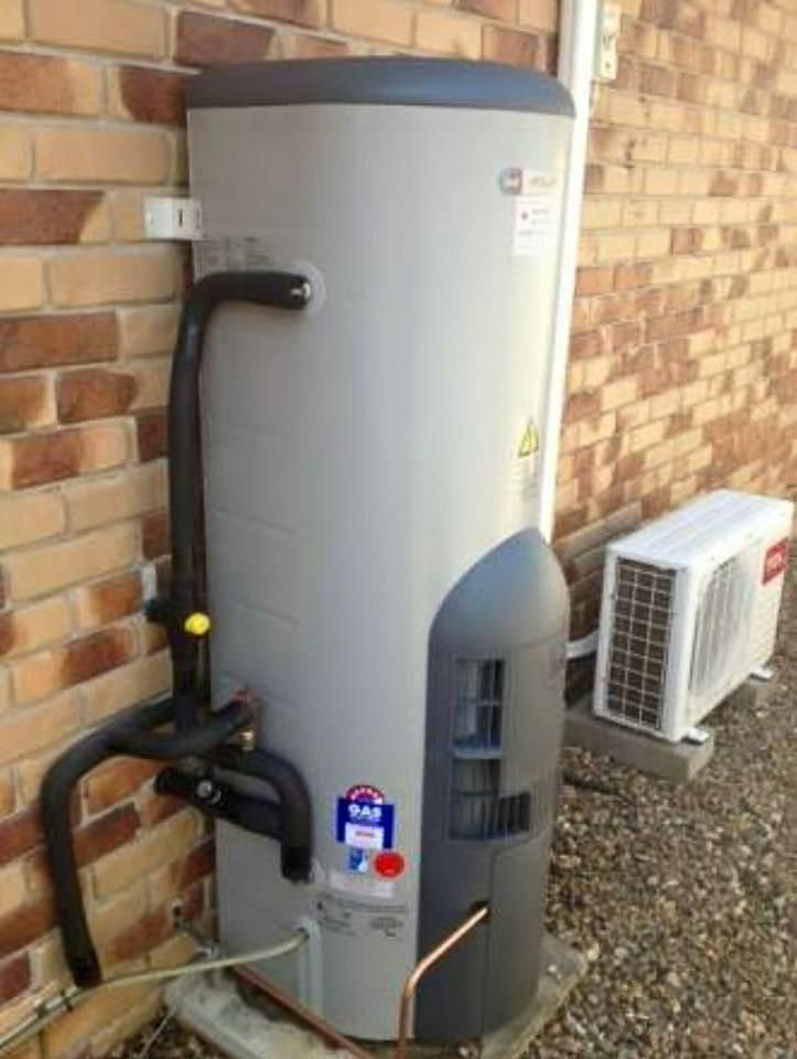 Water Heater is Attached to a Brick Wall Next to an Air Conditioner — ASAP Local Plumbing in Warrnambool, VIC