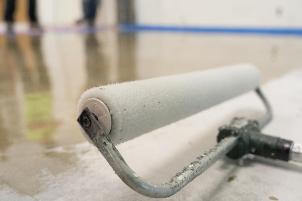 Polished concrete kitchen floor. Light-colored with visible aggregate, reflecting light.