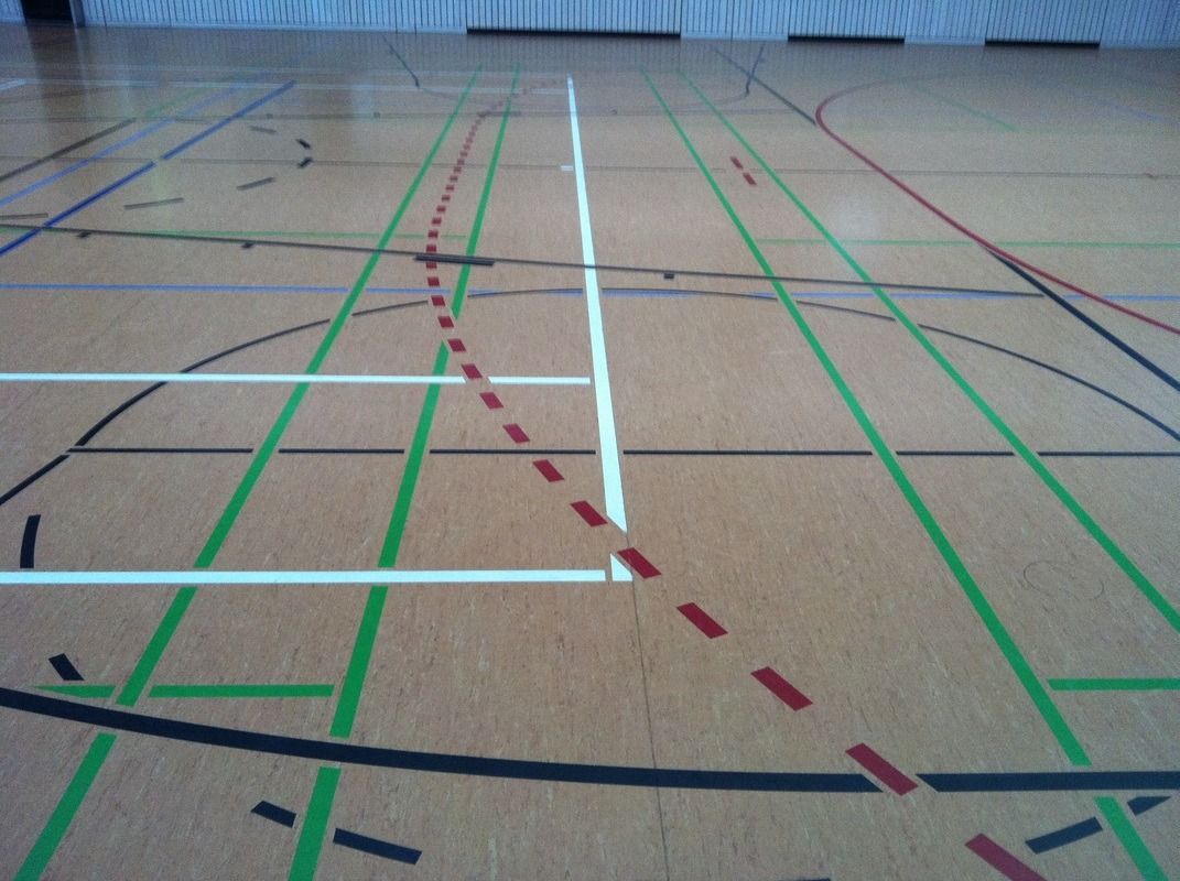 A basketball court with green and red lines on it, on a Hart's Athletic installed floor.