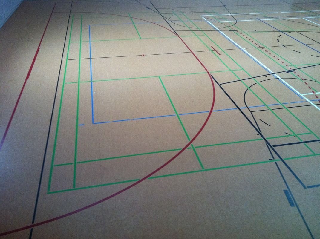 A basketball court with red and green lines, on a Hart's Athletic installed floor.