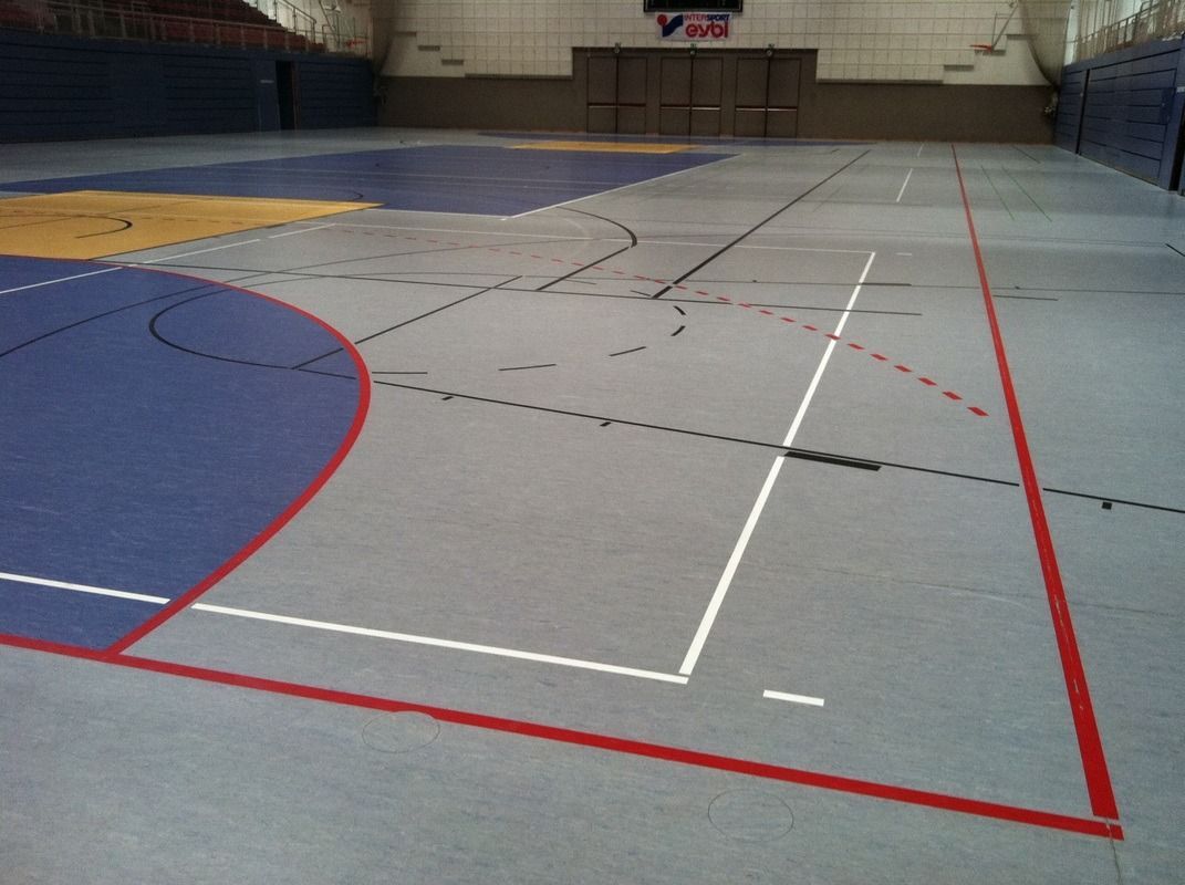 A basketball court with a red line on the corner, on a Hart's Athletic installed floor.