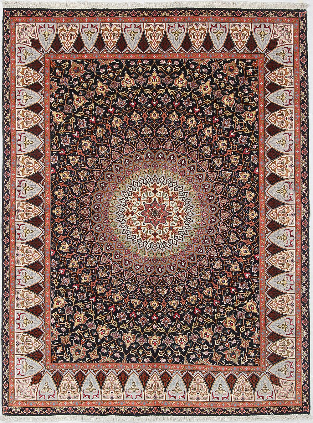 A rug with a circular pattern on it is on a white surface.