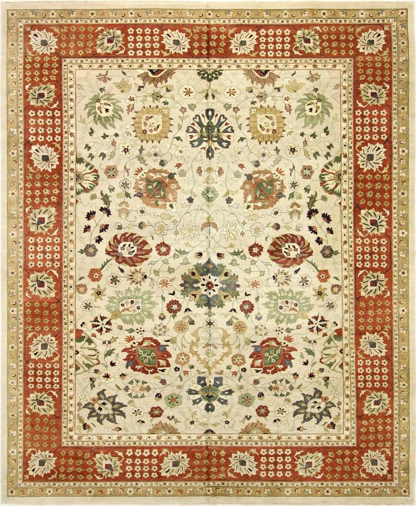 A rug with a floral pattern and a red border on a white background.