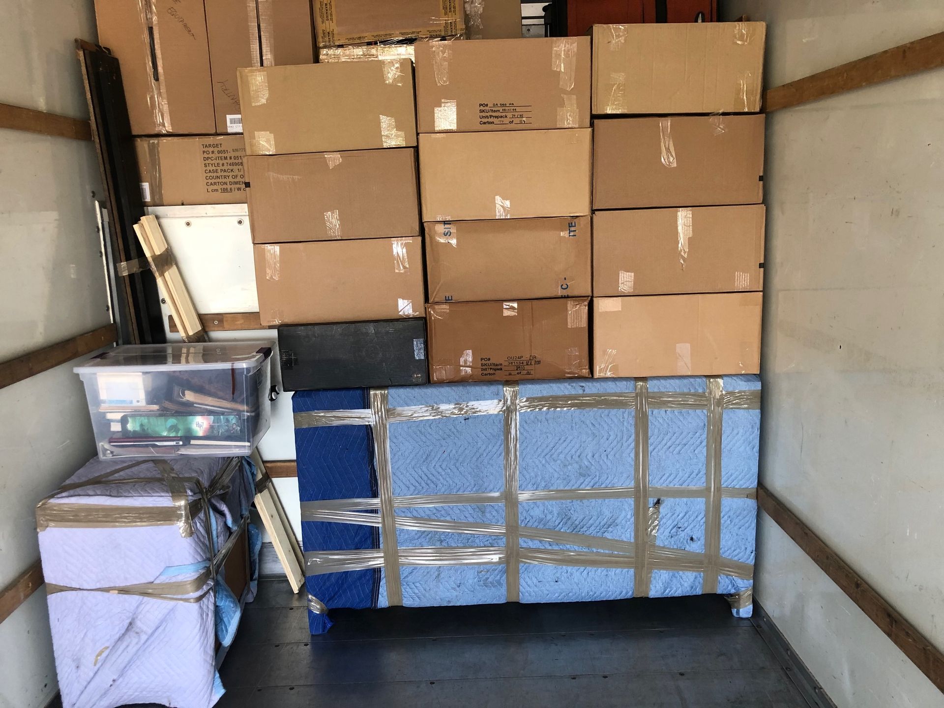 Boxes and furniture packed inside a moving truck.