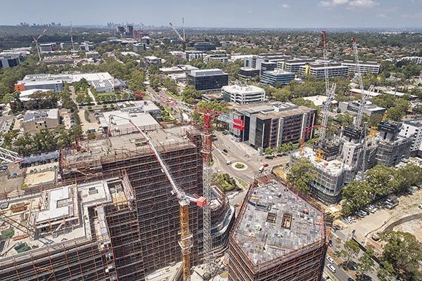 An aerial view of a city with a lot of buildings under construction.
