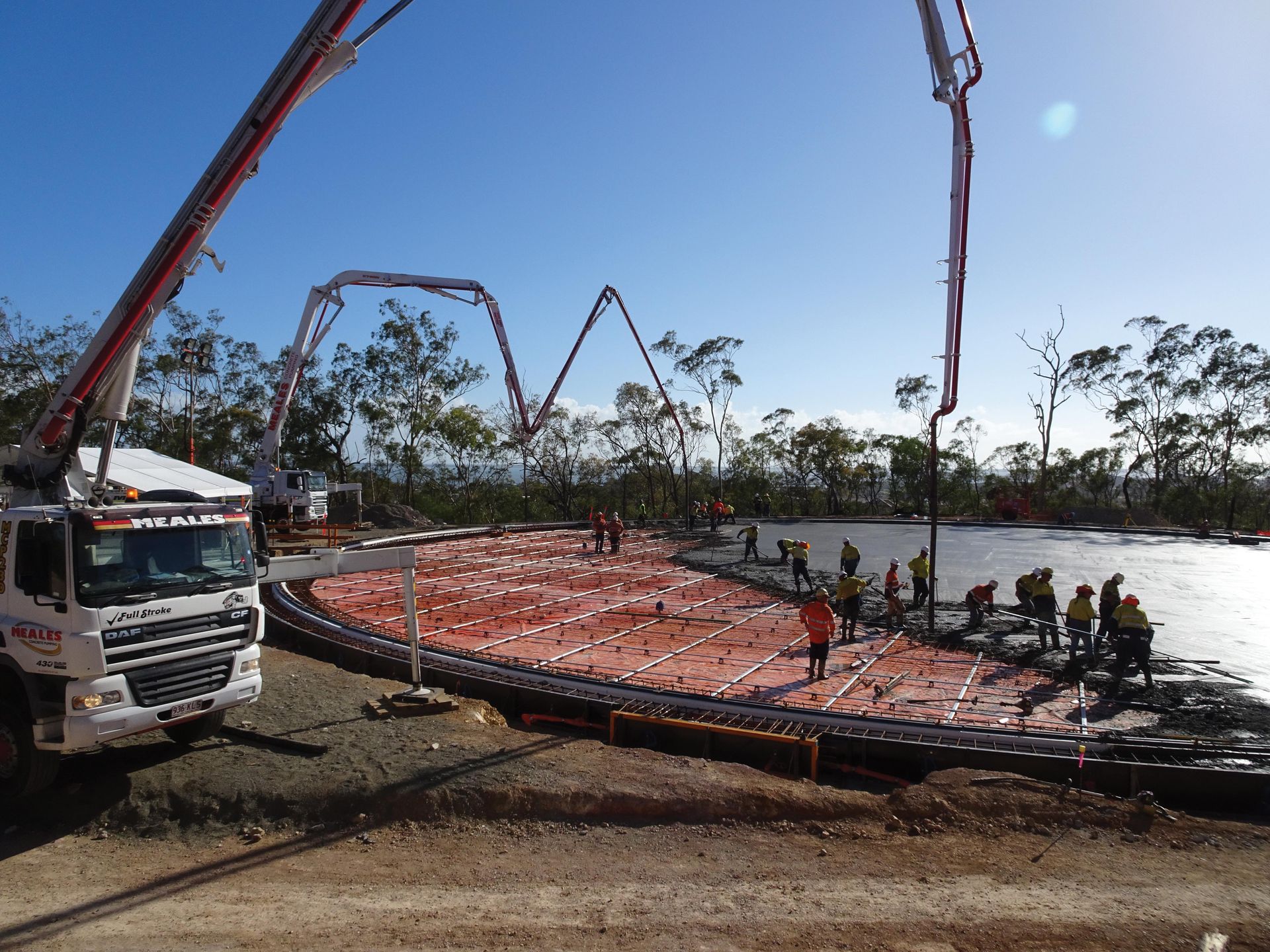 A concrete pump is being used to pour concrete on a construction site