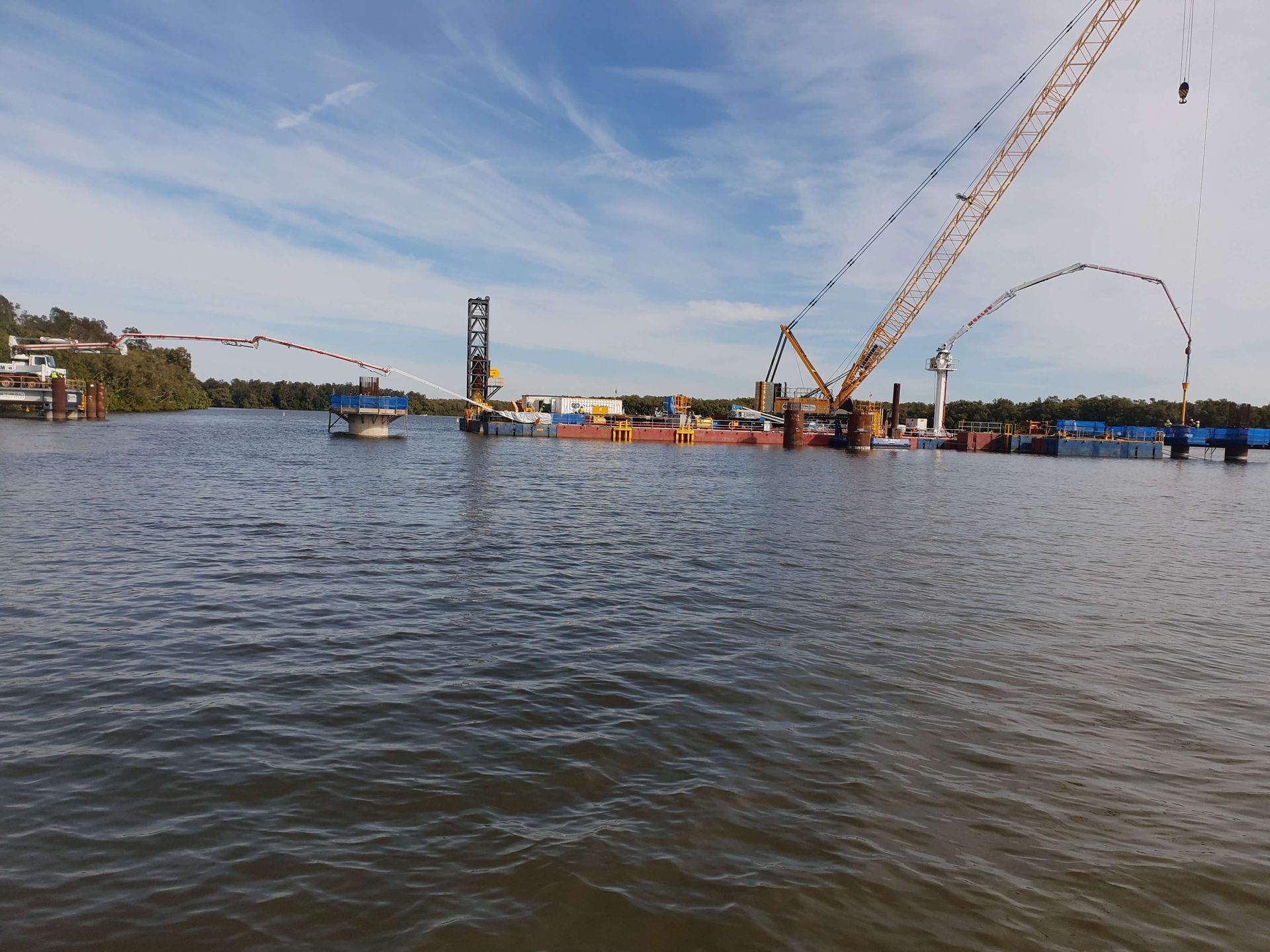 A large body of water with a crane in the middle of it
