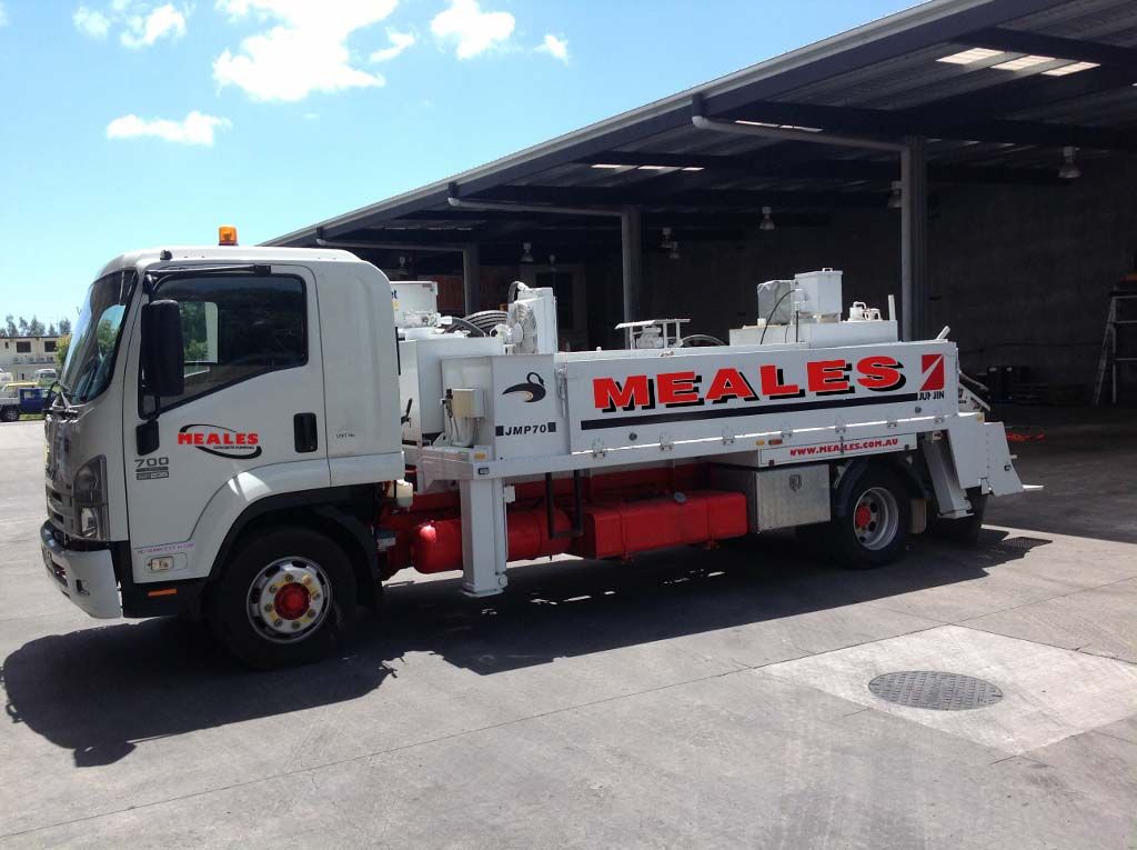 A white meales truck is parked in a parking lot