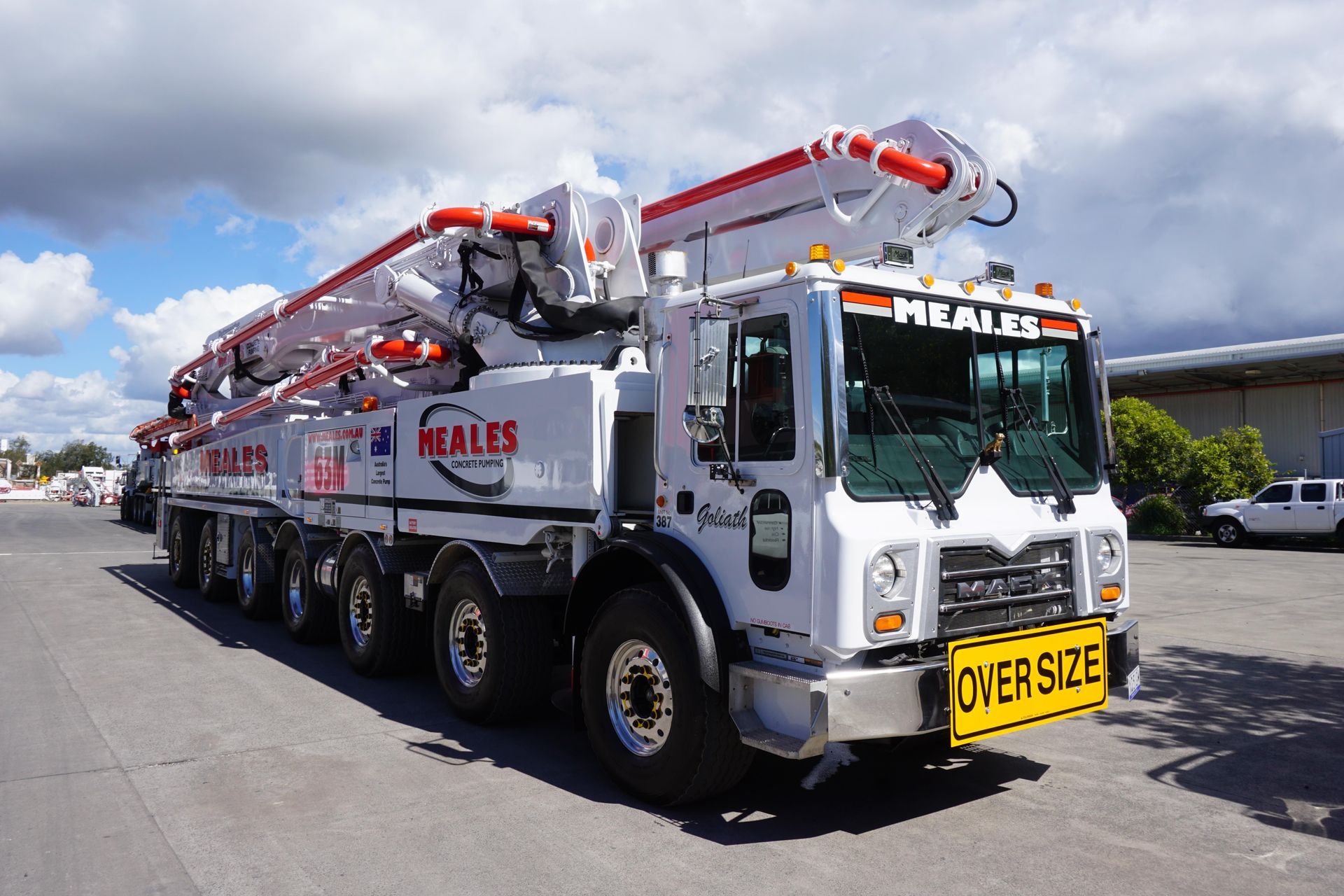 A large concrete pump truck is parked in a parking lot.