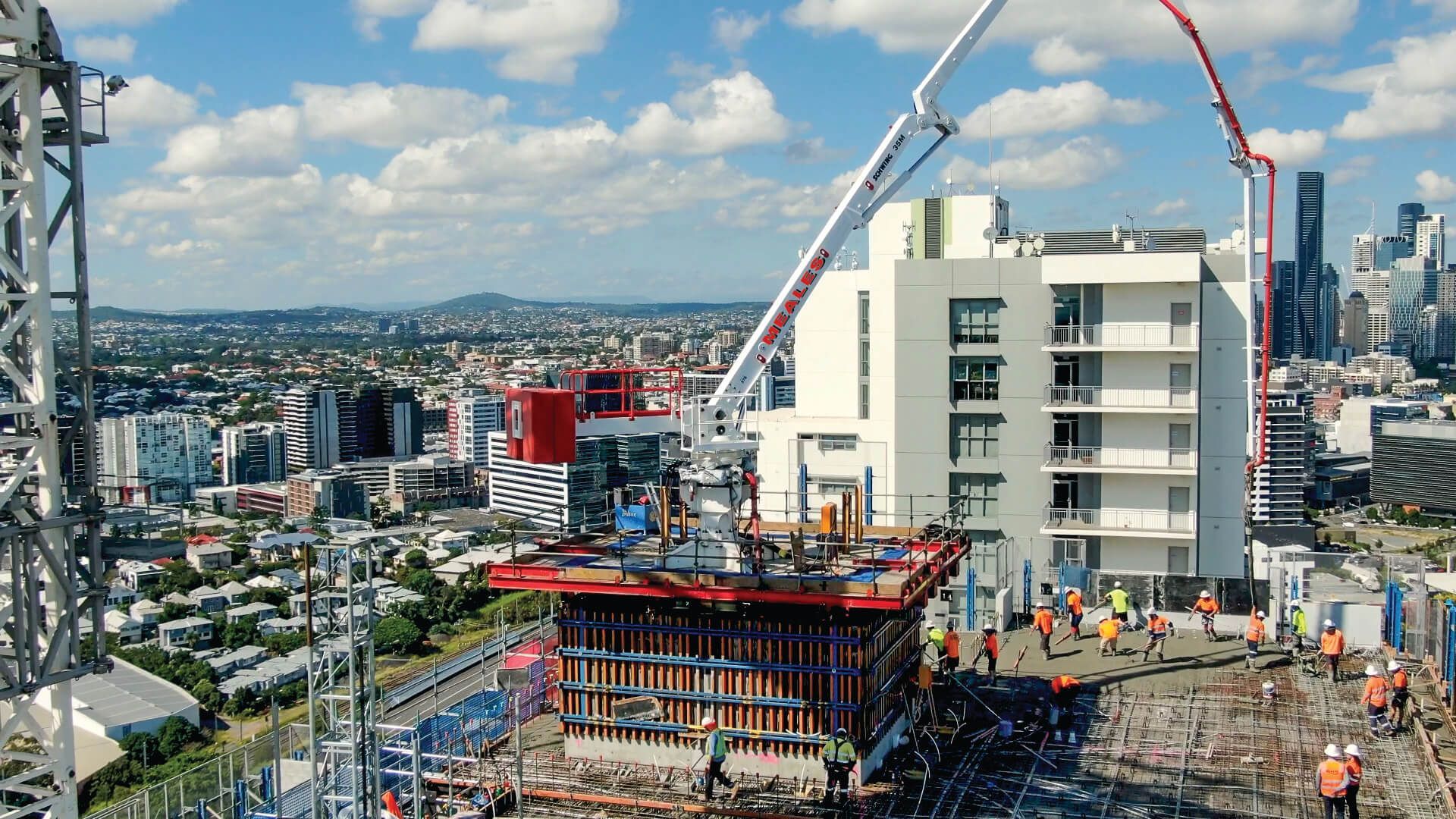 An aerial view of a building under construction in a city.