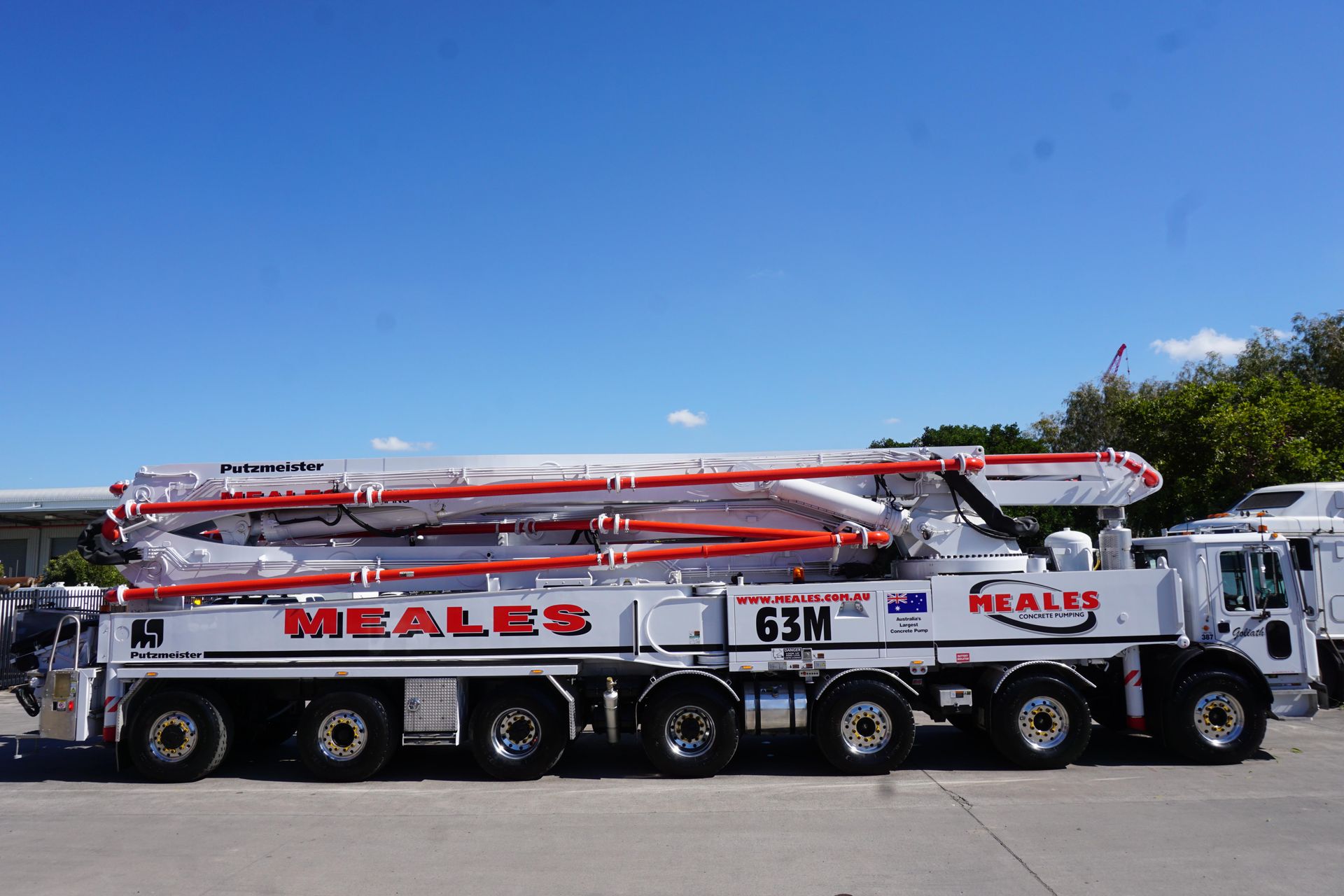 A meales concrete pump truck is parked on the side of the road