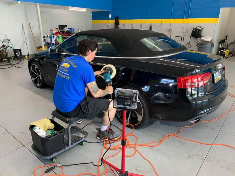 Man Using the Machine to Polish the Car — Erie, PA — Sparkle Clean Car Care