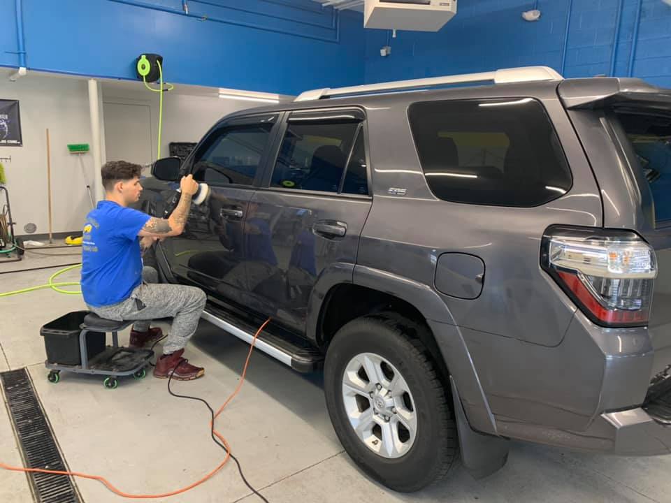 Man Polishing the Gray Car — Erie, PA — Sparkle Clean Car Care