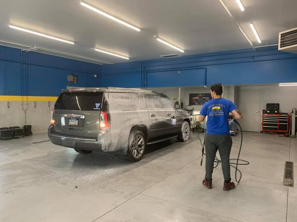 Worker Washing the Gray Car — Erie, PA — Sparkle Clean Car Care