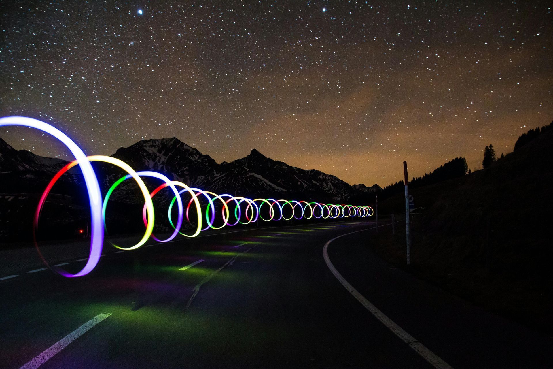 A long swirl of lights on a road at night