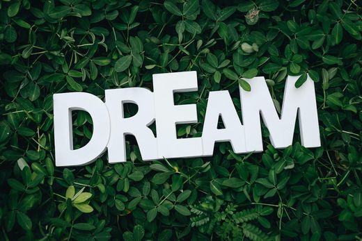 The word dream is written in white letters on a green background.