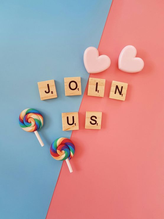 The word join is written in scrabble tiles next to lollipops and hearts.
