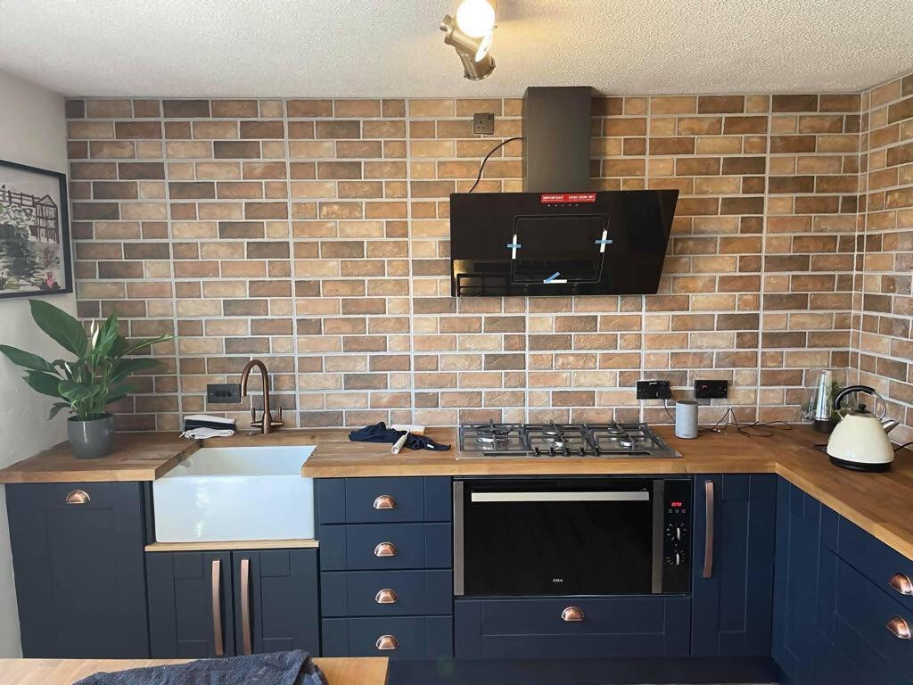 Modern kitchen with tiled wall