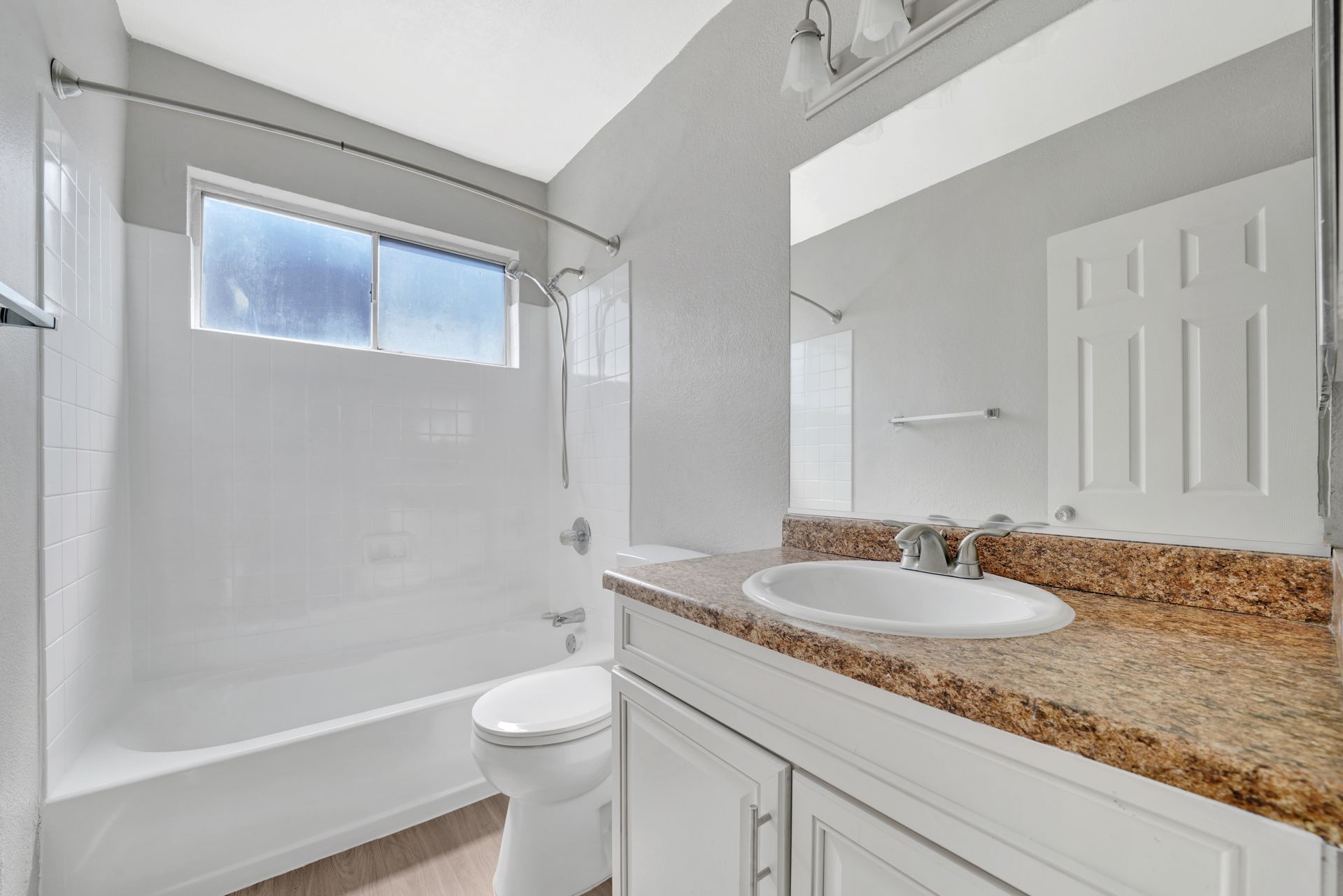 Photo of a bathroom with a wide counter and a shower/bathtub combination