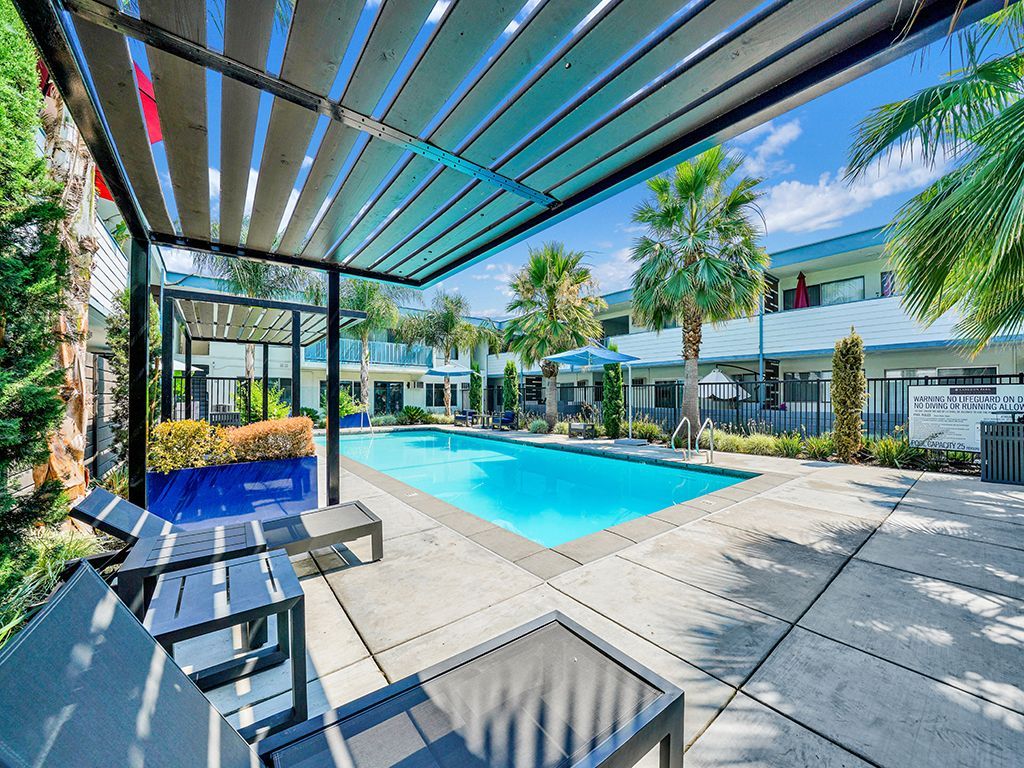 Photo of a poolside lounge area, looking out at the pool
