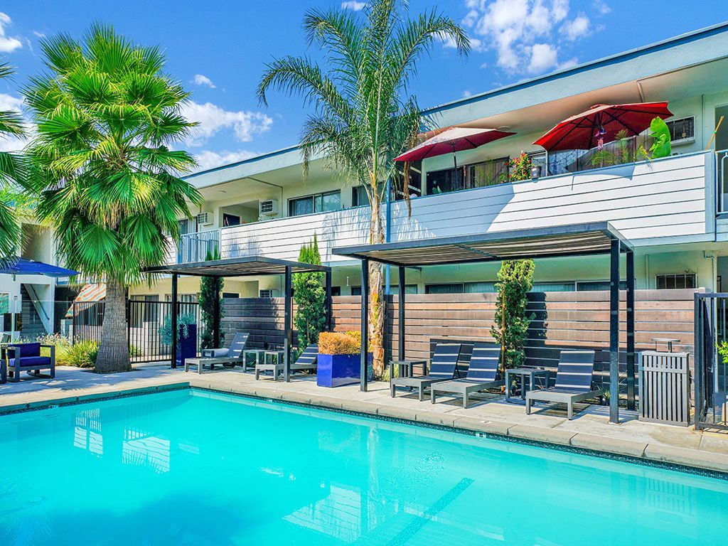 Photo of a pool, showing the poolside lounge area