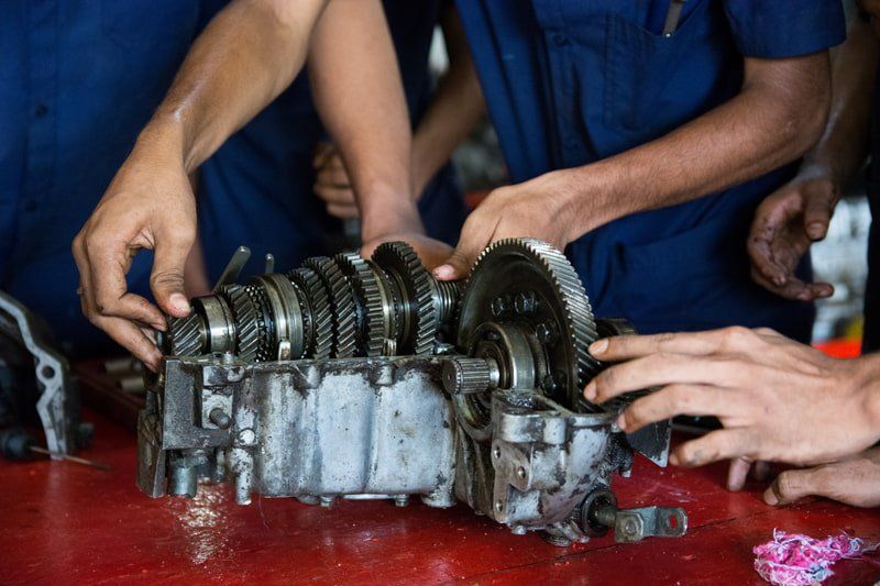 mechanics repairing transmission
