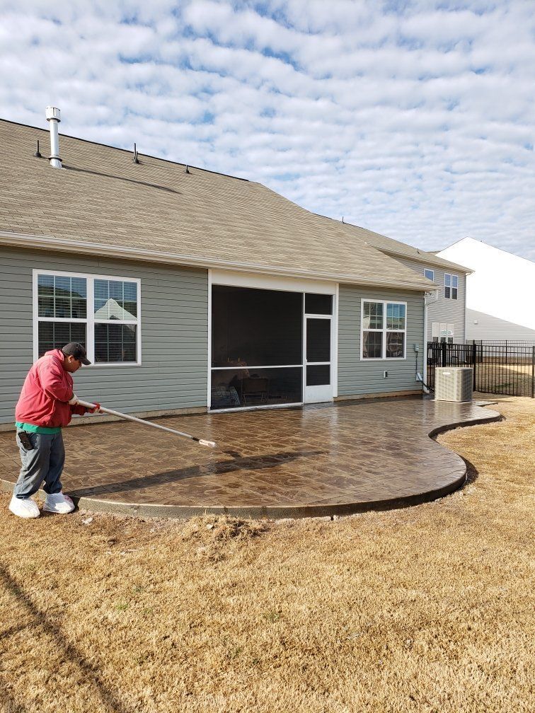 A concrete driveway leading to a house with a garage.