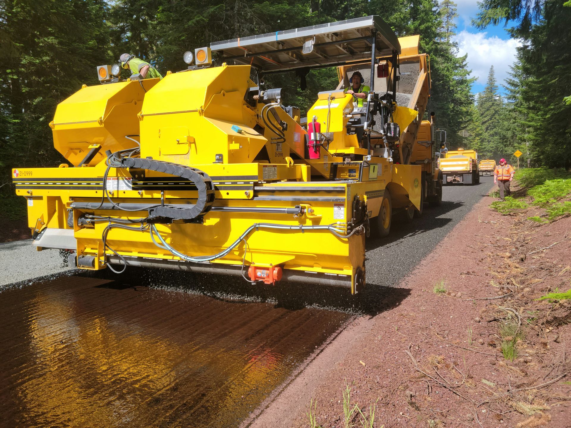 Crew sealcoating new asphalt