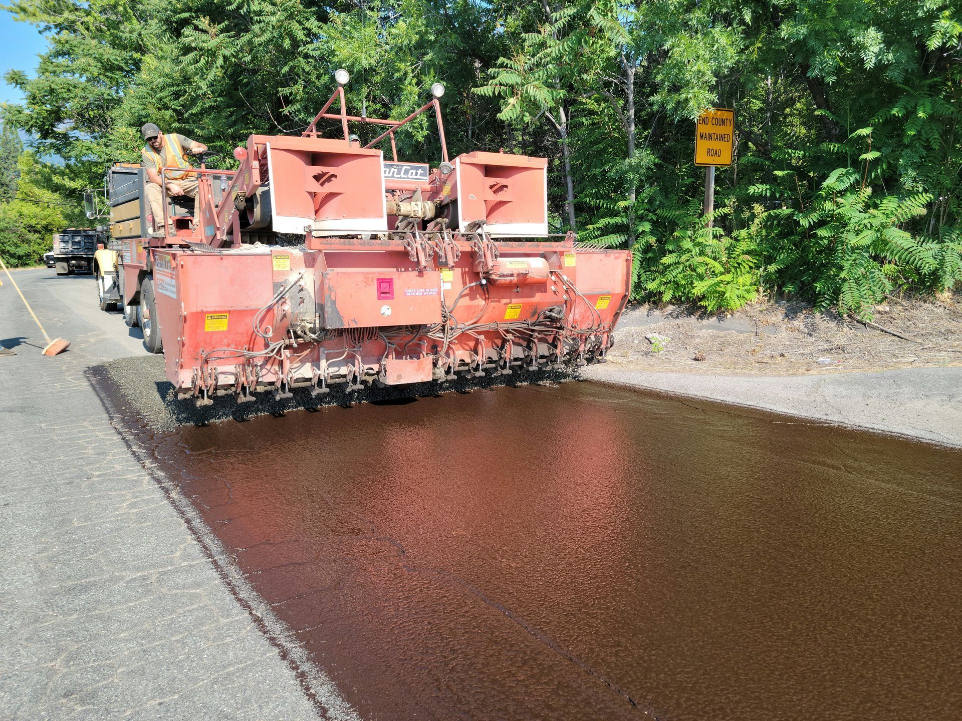 Crew seal coating old asphalt