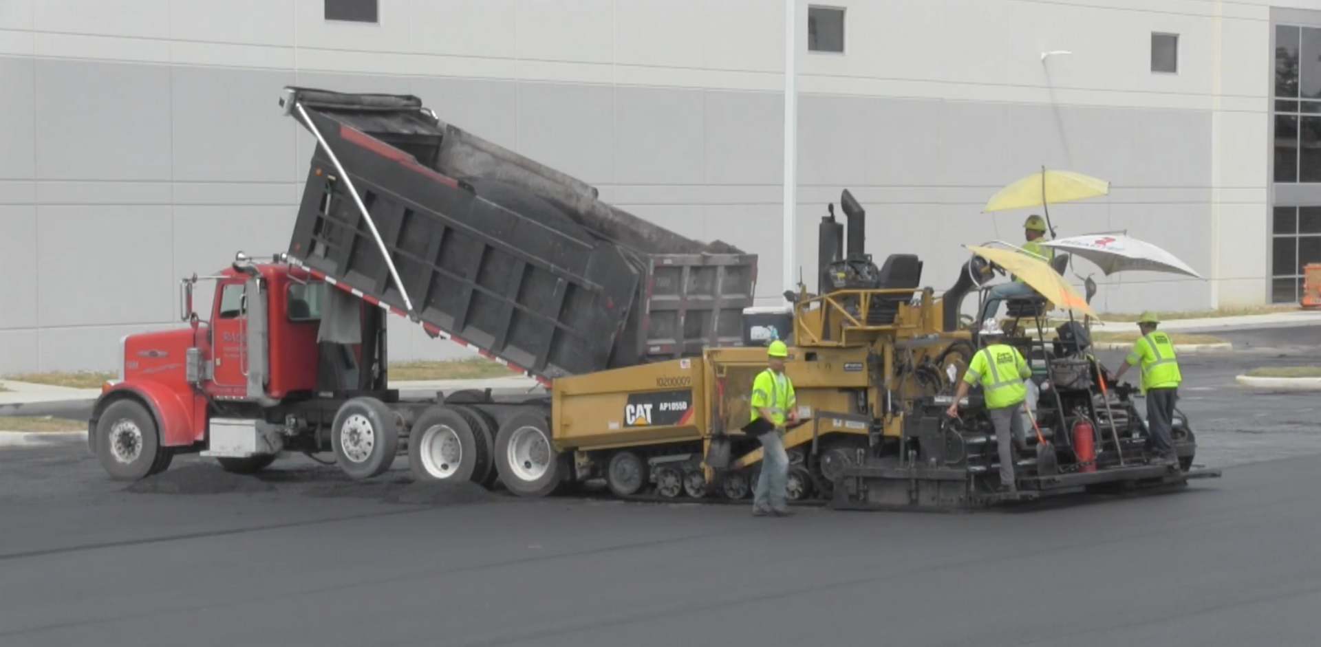 Asphalt crew resurfacing parking lot 